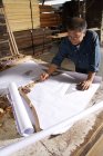 Craftsman writing on drafting paper — Stock Photo