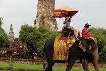 Tourist riding elephant — Stock Photo