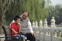 Grandfather with grandson in park — Stock Photo