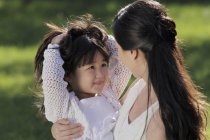 Mother and daughter playing outside — Stock Photo