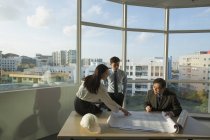 People discussing architectural plans — Stock Photo