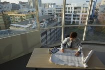 Architect working on architectural plans — Stock Photo