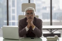 Businessman siting at desk — Stock Photo