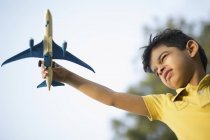 Boy playing with toy plane — Stock Photo