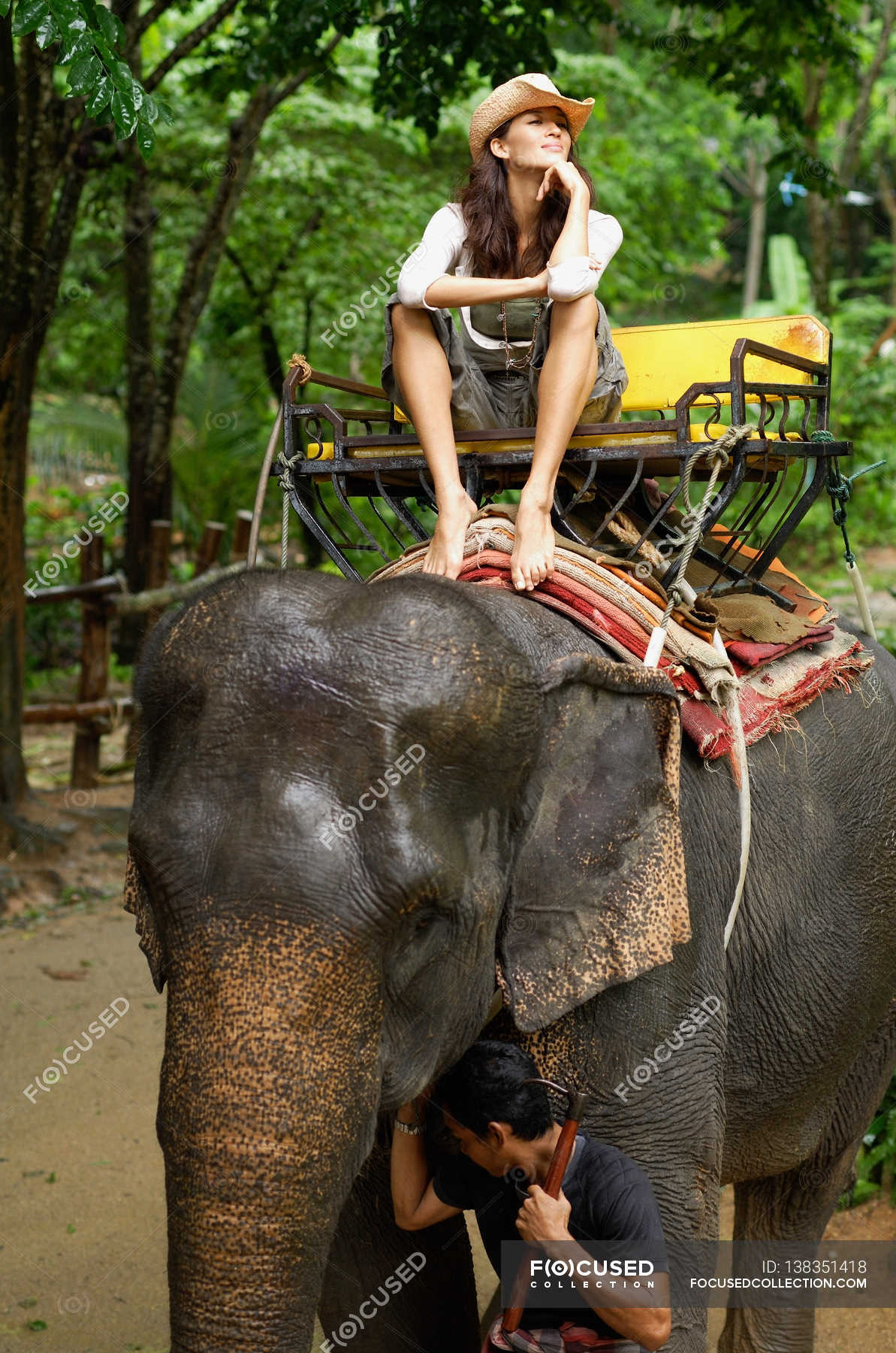 Woman riding on elephant — barefoot, Obscured Face Stock Photo