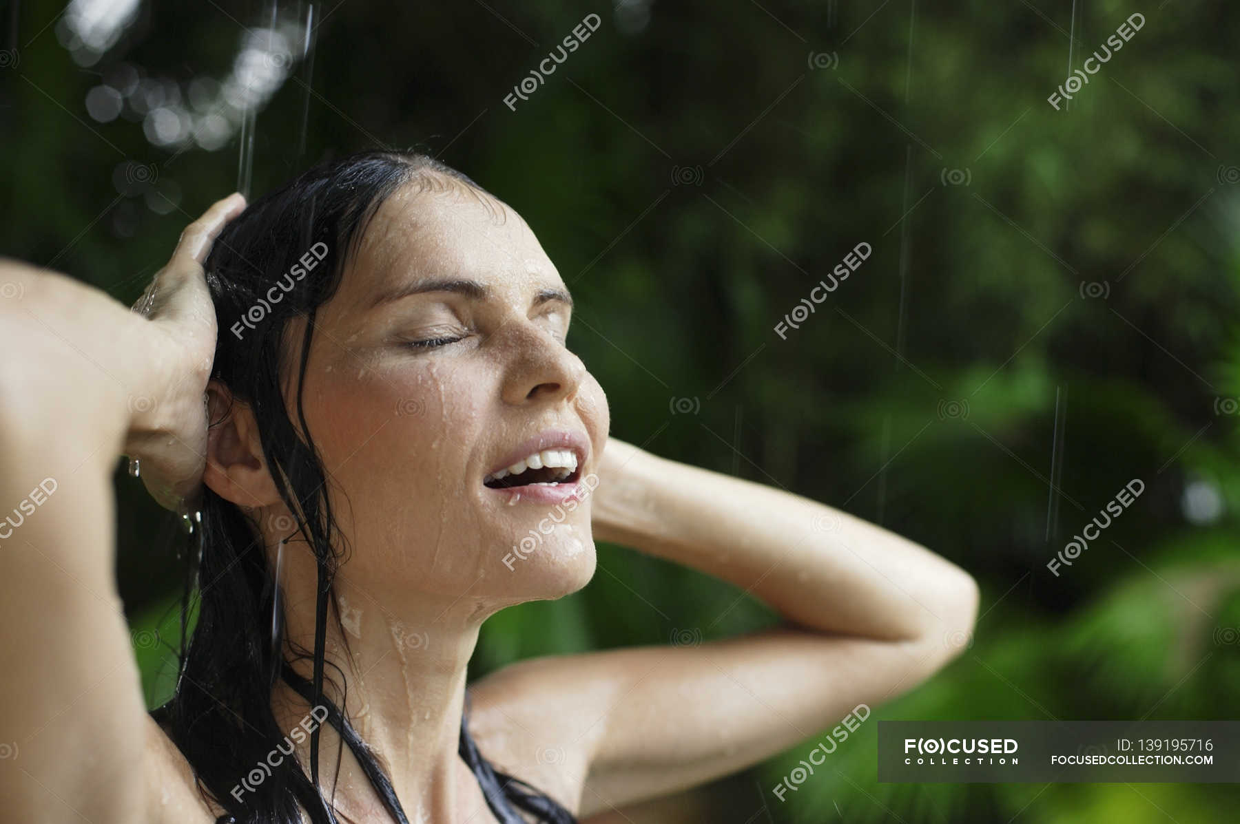 Woman in tropical rain shower — beauty, wet Stock Photo 139195716