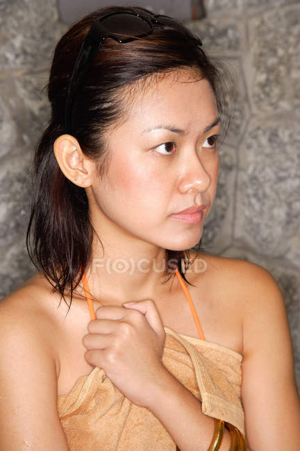 Woman holding towel to her chest — Stock Photo