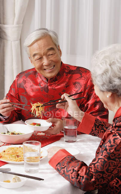 Elderly couple at dinner table — Stock Photo