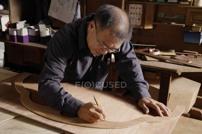 Carpenter working with wood on table — Stock Photo
