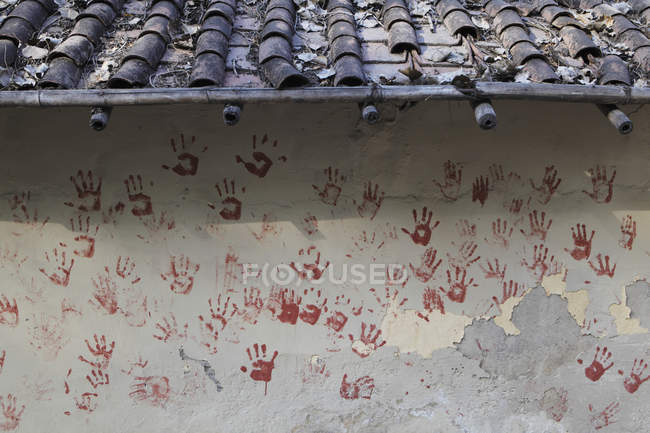 Red hand prints on wall — Stock Photo