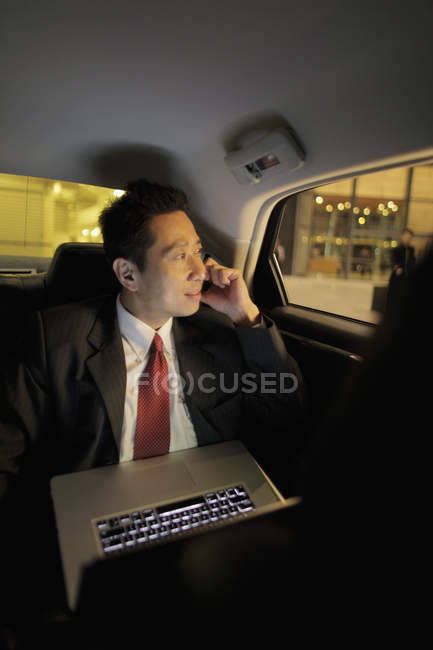 Бізнесмен сидить на задньому сидінні автомобіля — стокове фото