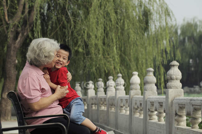 Бабуся обіймає і цілує онука — стокове фото