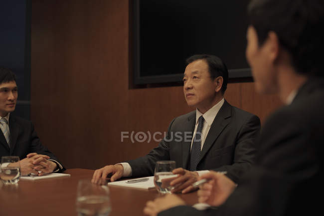 Three businessmen at business meeting — Stock Photo