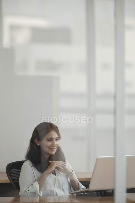 Femme d'affaires utilisant un ordinateur portable dans le bureau — Photo de stock