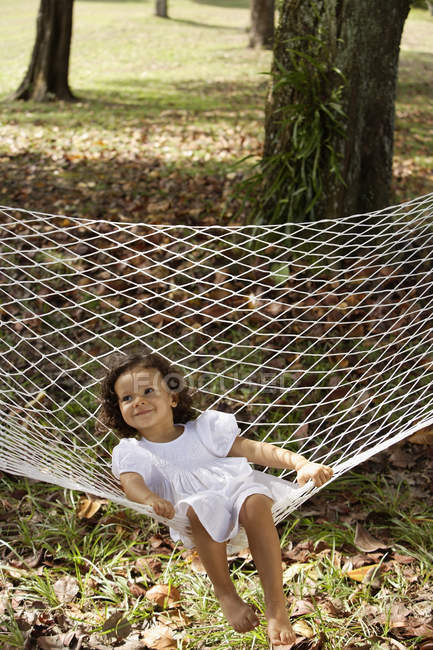 Girl sitting in hammock — Stock Photo