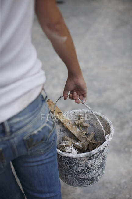 Woman holding bucket of scraps — Stock Photo
