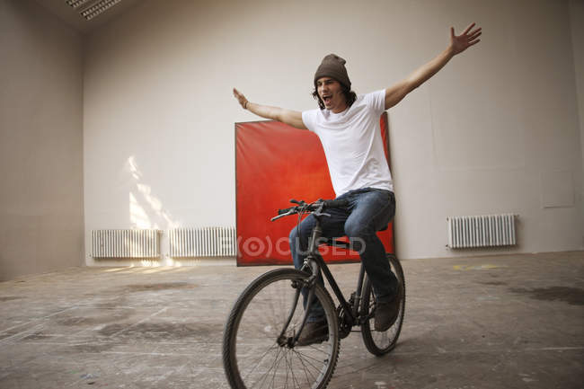 Young man riding bike — Stock Photo