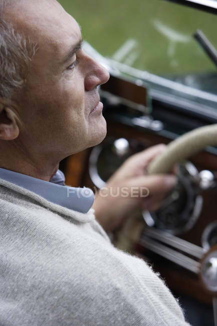 Homme assis à la voiture vintage — Photo de stock