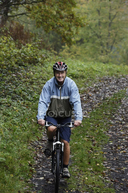 Senior man riding bike — Stock Photo