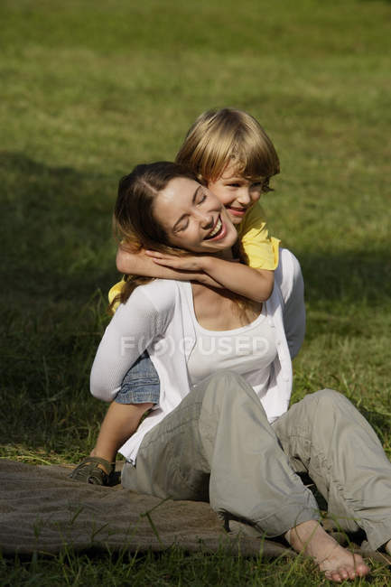 Boy hugging mother — Stock Photo