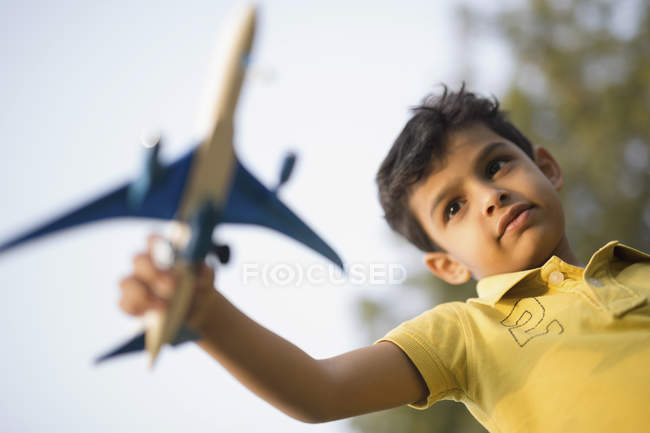 Boy playing with toy plane — Stock Photo