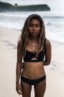 Приваблива молода жінка стоїть на пляжі — стокове фото