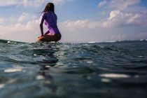 Female surfer on surf board — Stock Photo