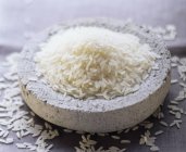 Uncooked rice in clay dish — Stock Photo