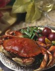 Closeup view of crab dinner with vegetables and white wine — Stock Photo