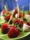 Chocolate-dipped strawberries with long stalks — Stock Photo
