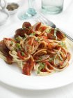 Spaghetti with clams on plate — Stock Photo
