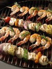 Closeup view of chicken and shrimp Kabobs on grill rack — Stock Photo
