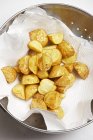 Deep fried potatoes drying — Stock Photo