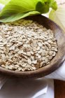 Closeup view of oats in a wooden bowl — Stock Photo