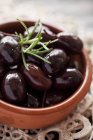 Marinated black olives with rosemary — Stock Photo