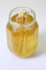 Honey comb in  jar — Stock Photo