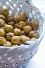 Walnuts in white basket — Stock Photo