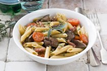 Penne pasta with chicken liver — Stock Photo