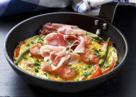 Frittata with ham and tomatoes — Stock Photo