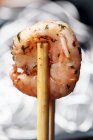 Herb on prawn with chopsticks — Stock Photo