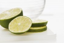 Slices lime on plastic board — Stock Photo