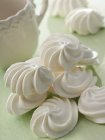 Meringues on green surface — Stock Photo
