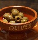 Green olives in bowl — Stock Photo
