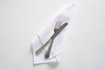 Top view of cutlery on a white napkin — Stock Photo