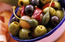 Bowl of marinated olives and capers — Stock Photo