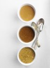 Different types of mustard in bowls — Stock Photo