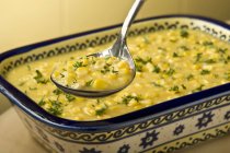 Antique Serving Spoon of Creamed Corn; Creamed Corn in Serving Dish — Stock Photo