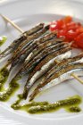 Grilled sardines on skewer with pesto — Stock Photo