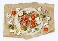 Raw pizza with salami and mushrooms — Stock Photo