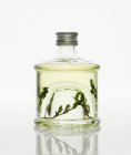 Closeup view of thyme vinegar in glass bottle — Stock Photo
